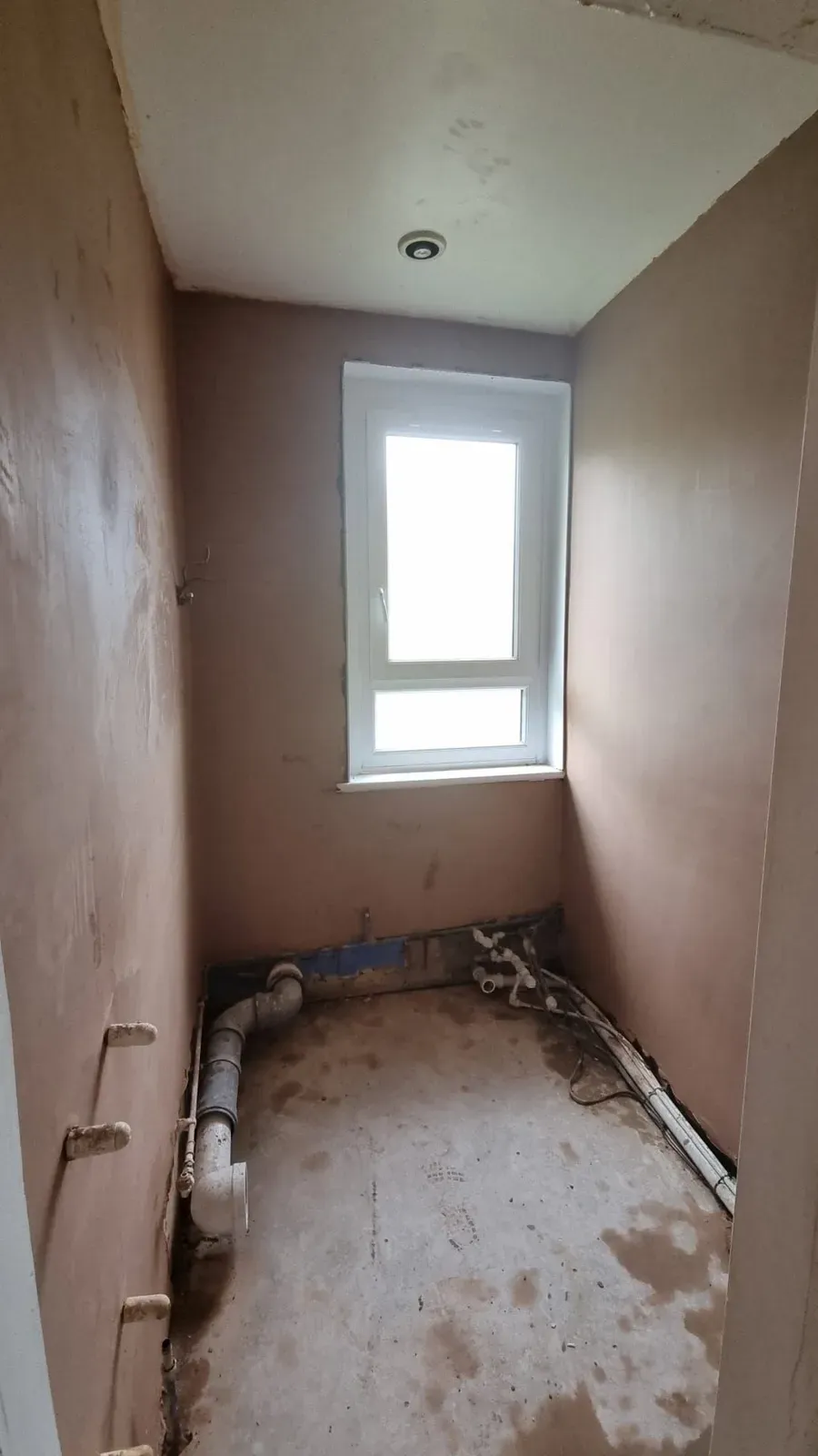 The same bathroom walls freshly plastered
