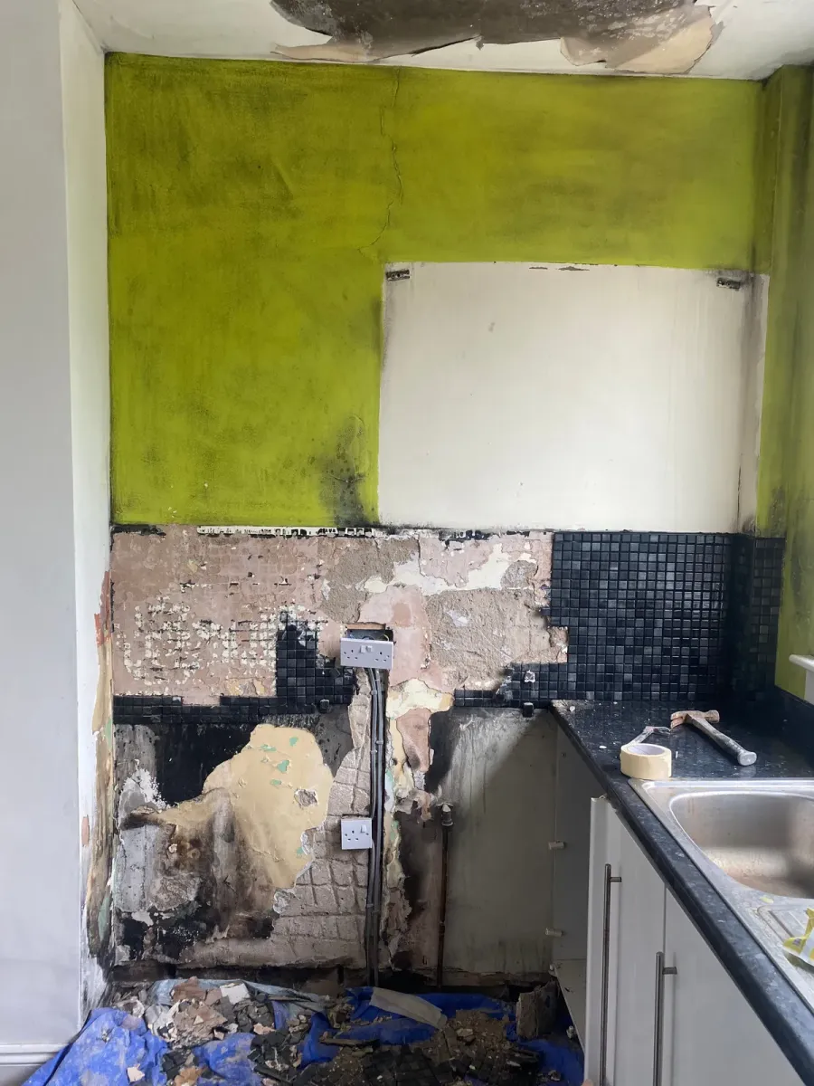 Kitchen wall blackened and stripped back after a fire