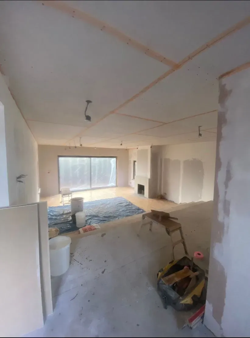 A large ceiling plasterboarded with the joints taped, part of a boarding package
