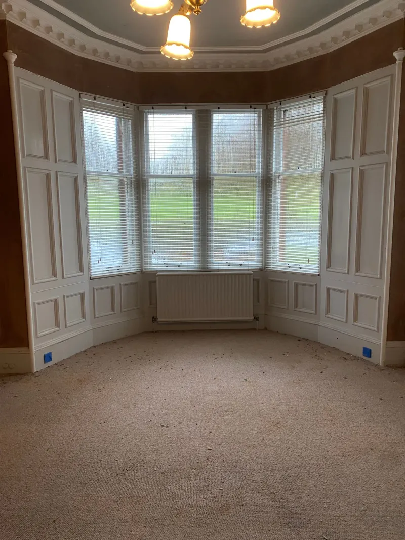 Bay window and cornicing in a period living room, walls freshly plastered